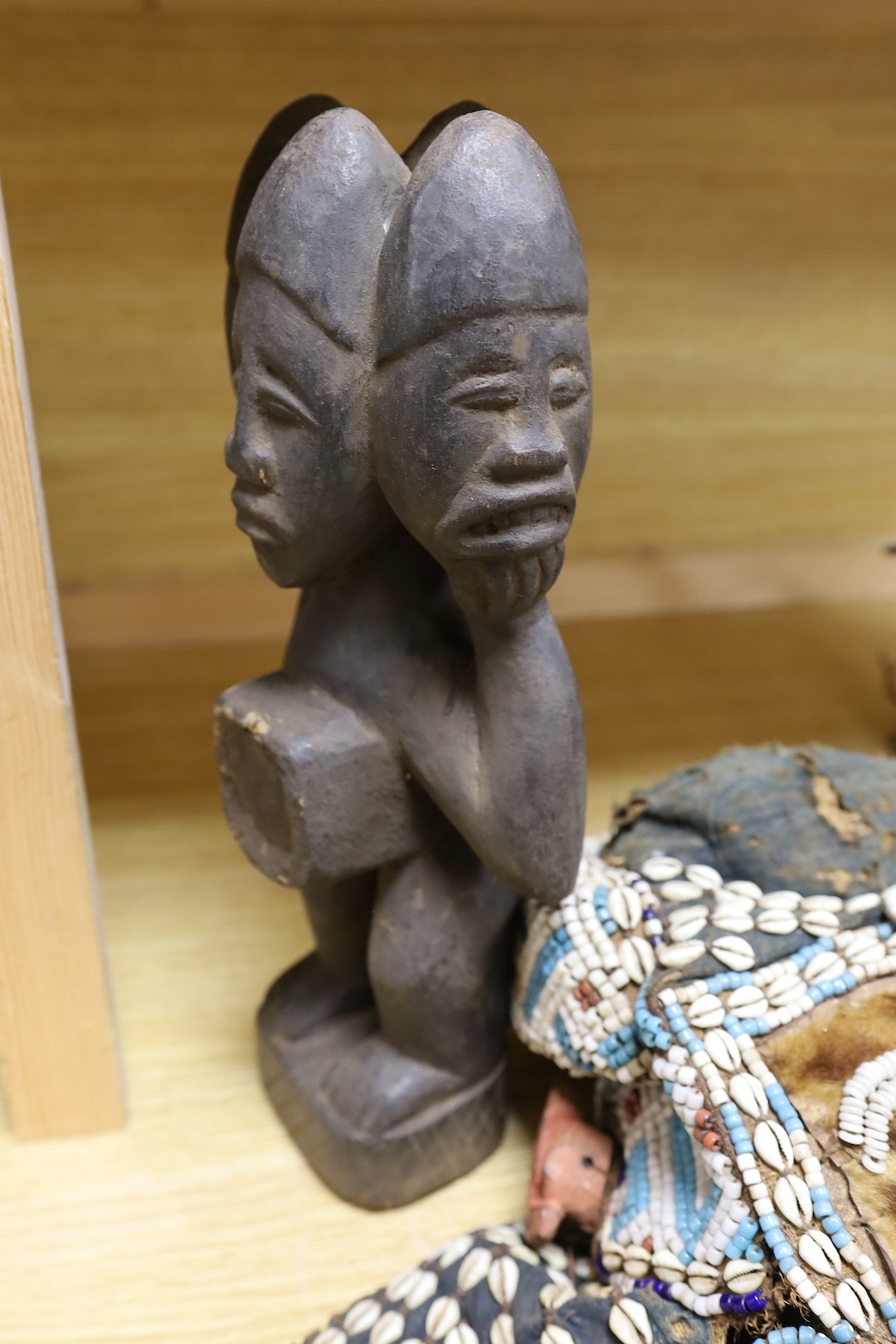 A group of Democratic Republic of Congo tribal carved wood figures and instrument and a Kuba style beadwork and shell mount mask